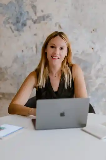 Kristina Nielsen at her desk with a laptop